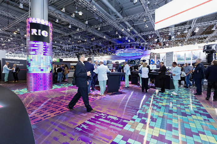 Colourful floor graphics and a decorated column at the MAN trade fair stand